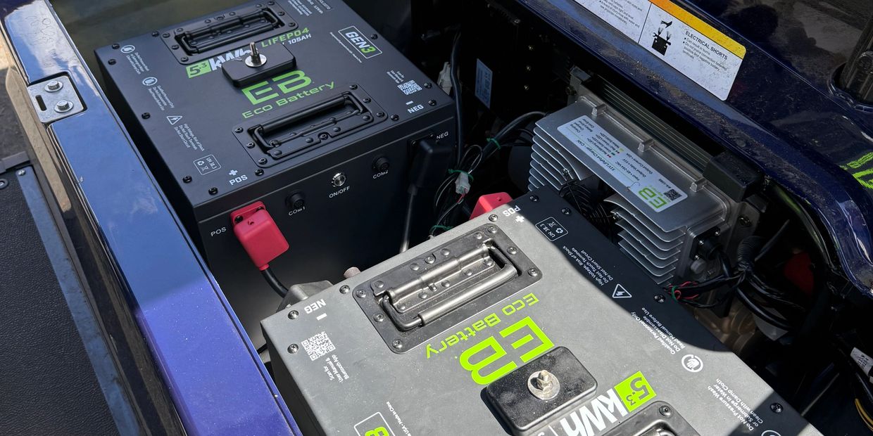 Two Eco Battery units installed in a vehicle's engine bay.