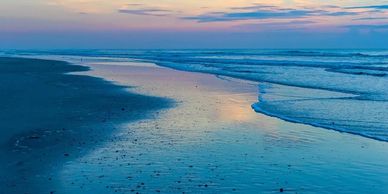 St. Augustine Beach sunrise with golden morning light over the Atlantic Ocean, peaceful waves, and s