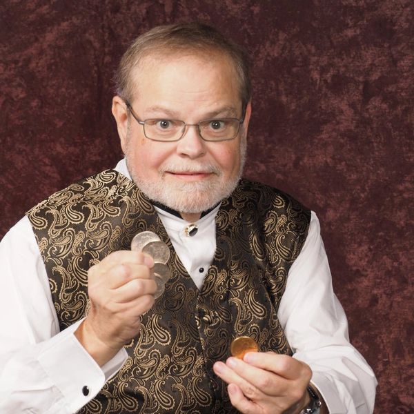 Al holding up coins.