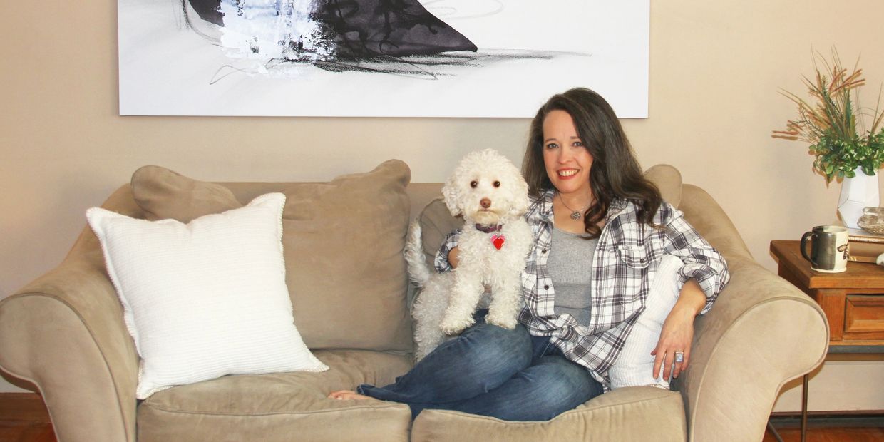 Artist Erin Leigh Boughamer on the couch in her studio.