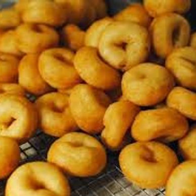 Freshly made small donuts with a golden brown color.