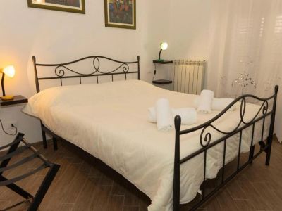 Cozy bedroom with a wrought iron bed and neatly arranged towels.