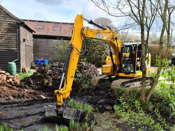 JCB digger restoring a wildlife pond in a wildlife garden - Jim Ashton - Wild Horizons