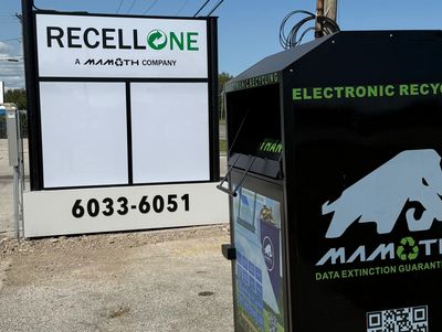 Electronic recycling drop-off with Mamoth branding and contact sign.