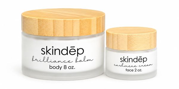 Skindep body balm and face cream in frosted jars with wooden lids.