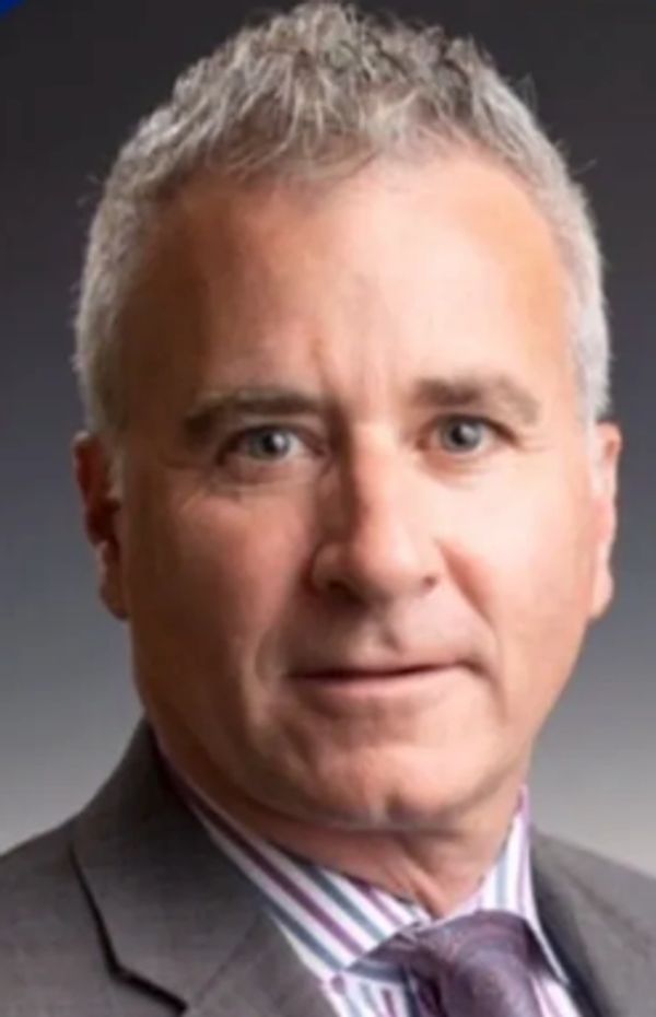 Middle-aged man in a suit and tie.
