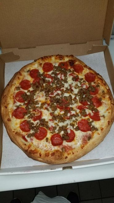 Pepperoni and sausage pizza in a box.
