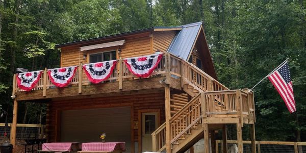 Cabin decorated with patriotic banners and an American flag.