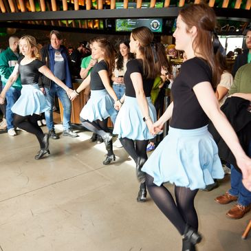 A group of young women performing an Irish dance.