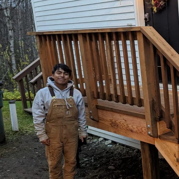 Picture of Arturo in front of porch deck.