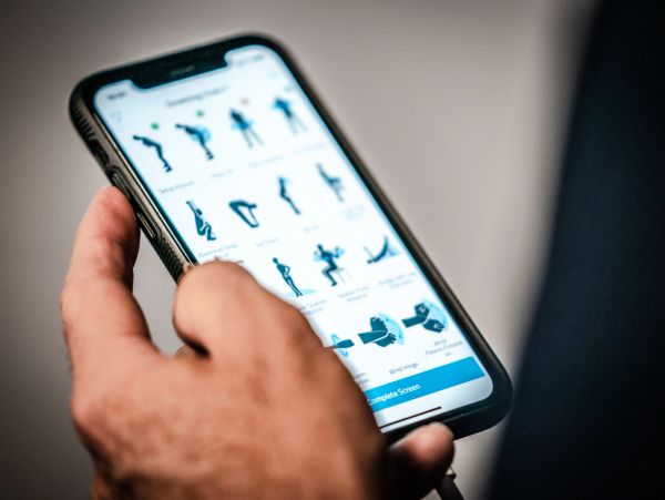 Person using a fitness app on a smartphone.