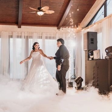 Bride and groom dancing on a cloud-like floor at their wedding.