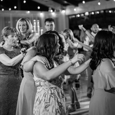People dancing in a conga line at a party.
