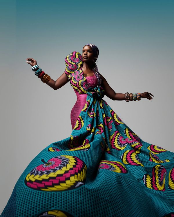 Elegant model wearing a flowing gown with gold accessories