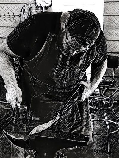 Bladesmith forging a knife on an anvil