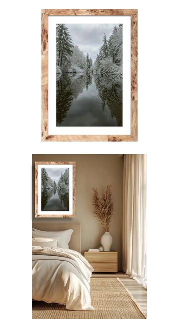 Framed winter forest reflecting on calm water in cozy bedroom.