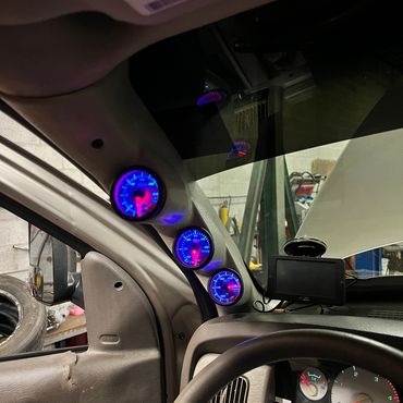 3rd gen cummins with a set of 3 glowshift gauges on a pillar mount