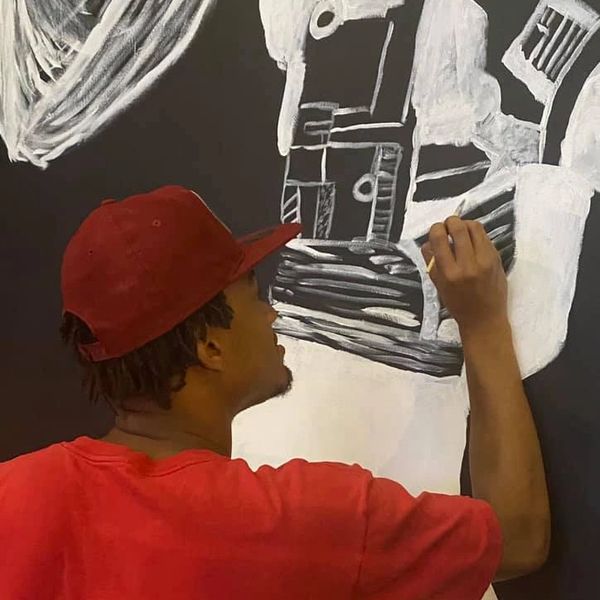 Lavonous painting a mural.