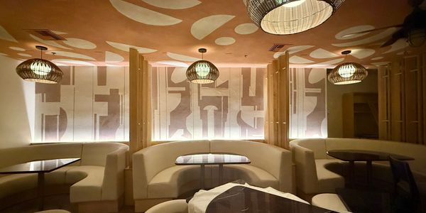 Cozy, stylish restaurant interior with warm lighting.