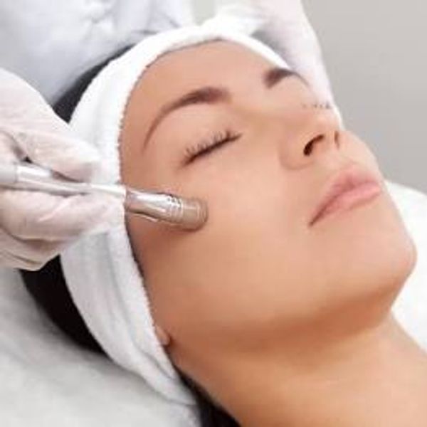 A woman receiving a microdermabrasion treatment
