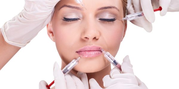 Aesthetic model with multiple syringes near face