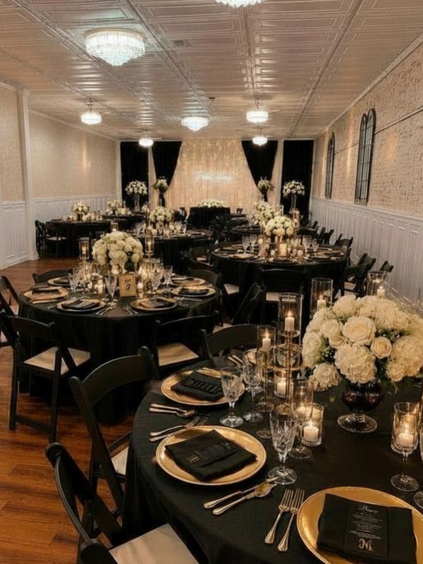 Elegant wedding reception setup with black and gold decor.