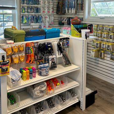 Hardware store aisle with tools and accessories.