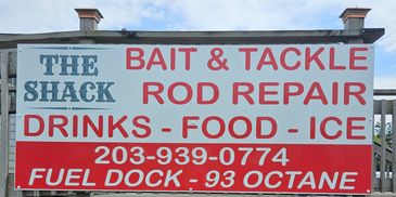 Sign for bait, tackle, rod repair, food, and fuel services.