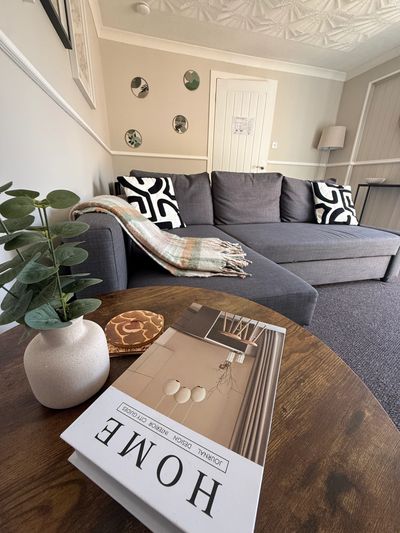 Cozy living room with gray couch and decorative pillows.