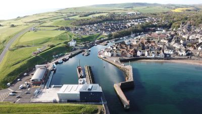 Aerial view of a coastal town with a harbor.