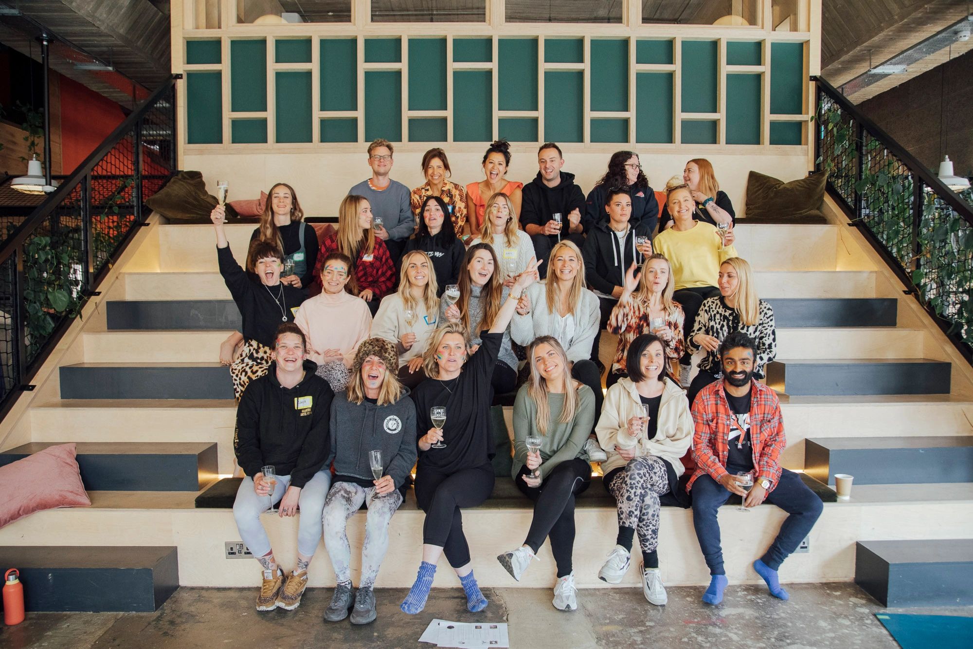 Group of people posing and celebrating indoors.