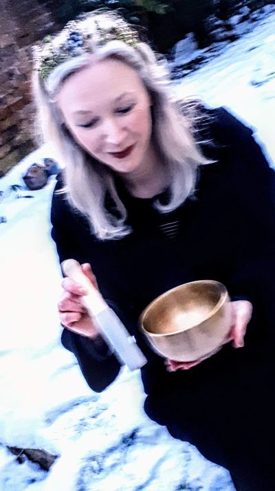 Sound therapist Kay Rose playing Tibetan singing bowl in the snow