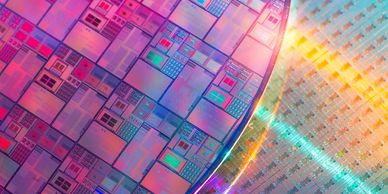 Close-up of a colorful semiconductor chip with intricate circuitry.
