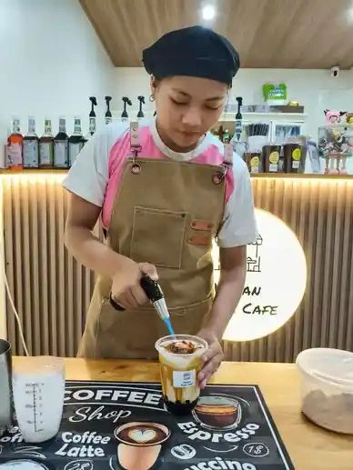 Barista preparing beverage.