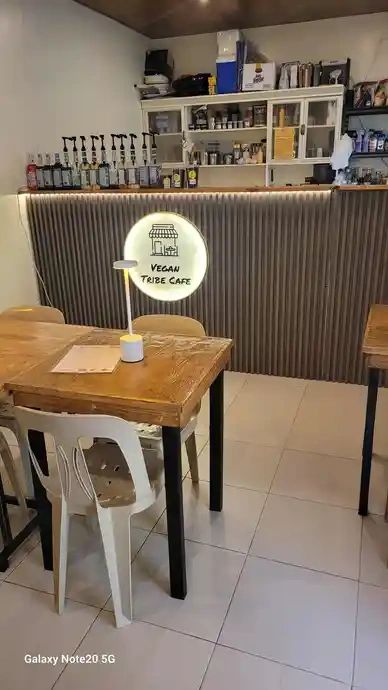 Interior of a cozy vegan cafe with wooden tables.