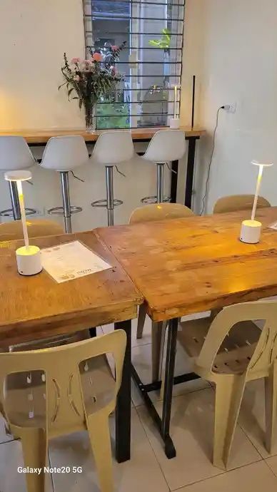 Cozy cafe interior with wooden tables and modern chairs.