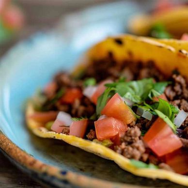 Three tacos on a plate.