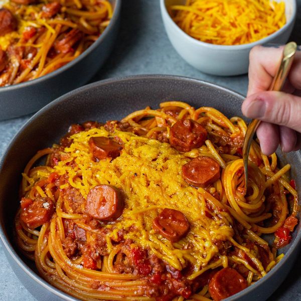 Filipino spaghetti with sweet tomato sauce, hotdogs and rice. 