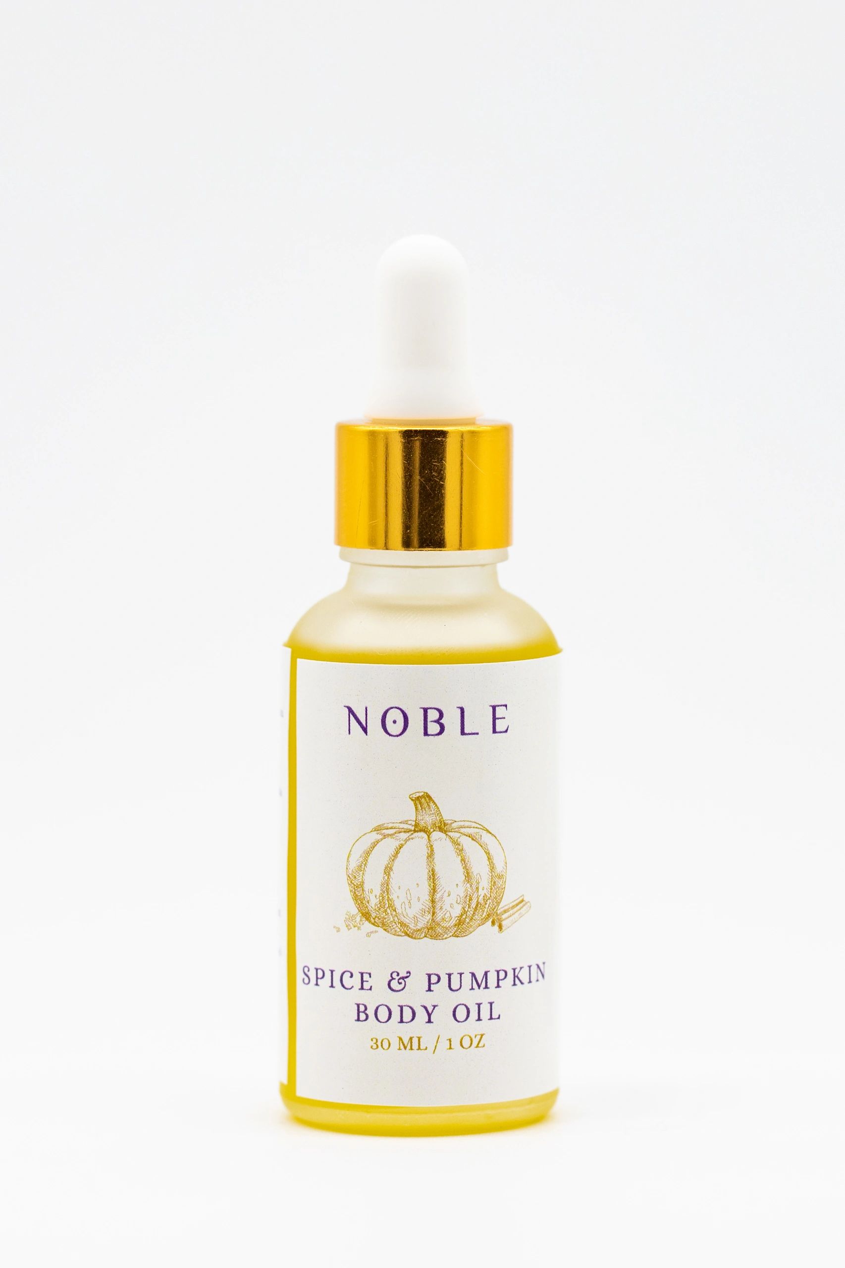 Bottle of Noble Spice &amp; Pumpkin Body Oil with gold dropper cap.