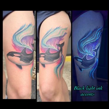 Colorful orca tattoo with black light ink accents.