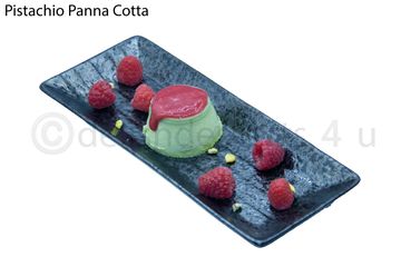 Pistachio panna cotta dessert with raspberry sauce and fresh raspberries on a black plate.