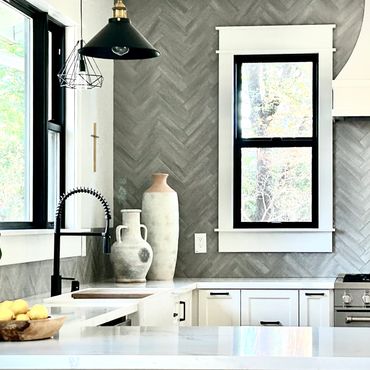 Modern farmhouse white shaker kitchen with dramatic neutral grey herringbone backsplash and rustic d