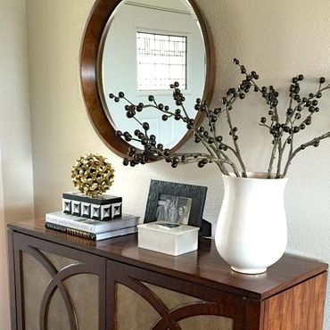 Contemporary decorscape in entryway with round mid mod mirror