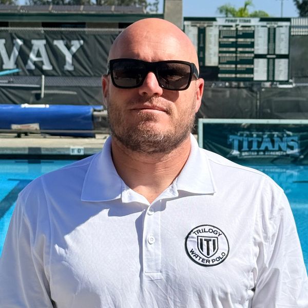 Man in sunglasses and Trilogy Water Polo shirt by pool.