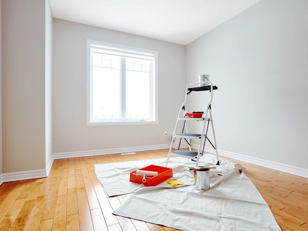 A room with a ladder for painting the walls