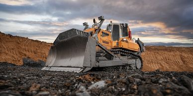 Large bulldozer working on a rocky terrain.