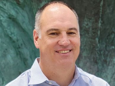 Smiling middle-aged man outdoors.