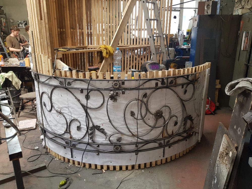 Hand-formed wrought ironwork balustrade under construction in the workshop