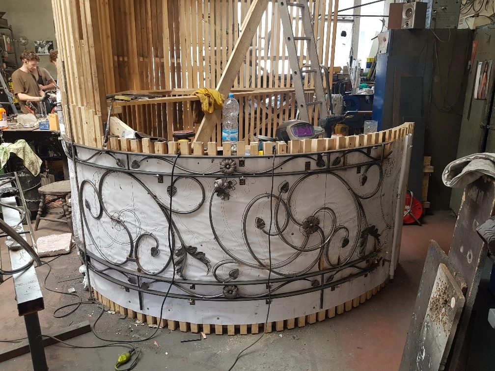 Hand-formed wrought ironwork balustrade under construction in the workshop