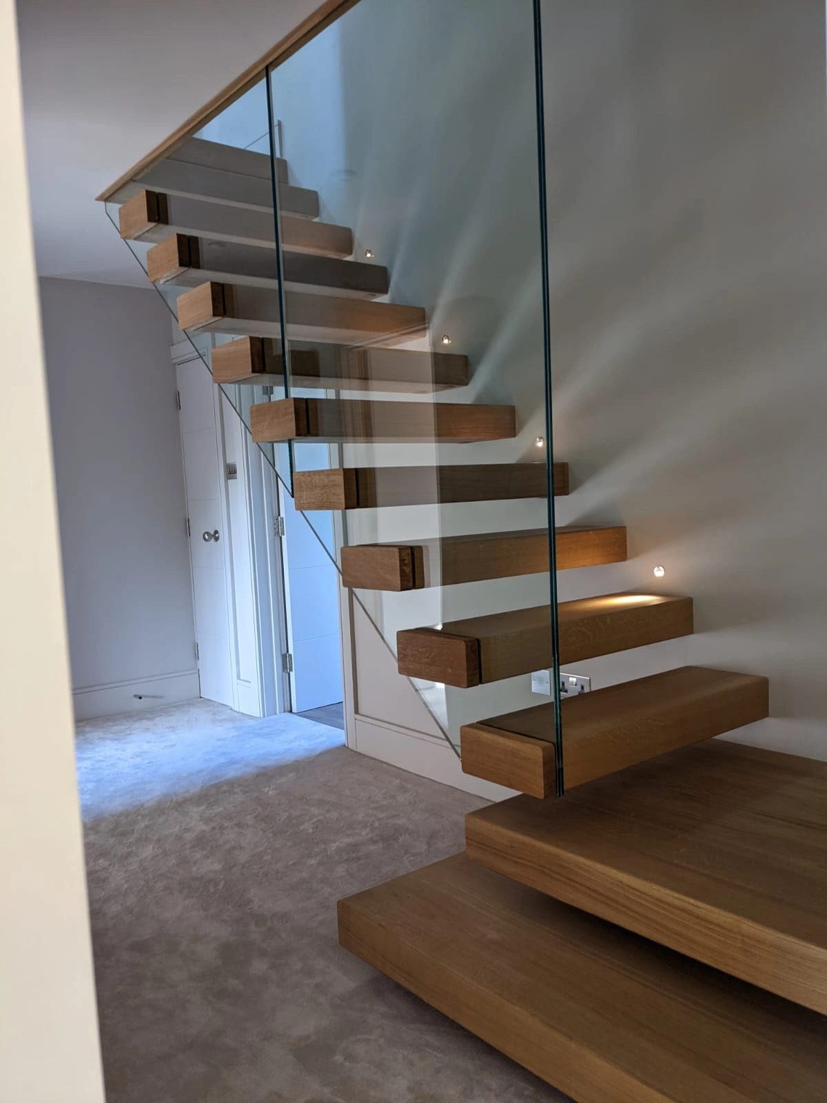 Cantilevered timber treads with a frameless glass balustrade